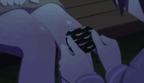 three girls are sitting on a bench in the dark