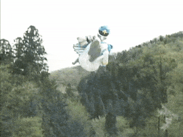 a person in a blue and white costume is jumping in the air