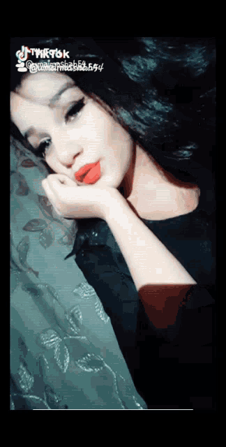 a girl with red lipstick is taking a selfie with tiktok written in the corner