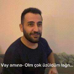 a man with a beard is sitting on a couch with a foreign language on the bottom .
