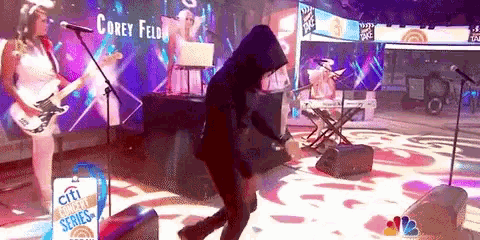 a person in a black hoodie is dancing on a stage in front of a sign that says citi rewards series