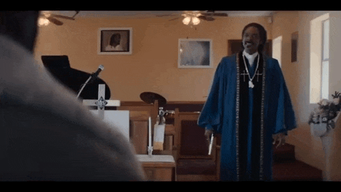a man is standing in a church holding a gun .