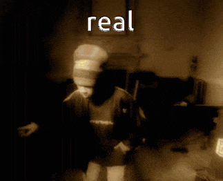 a blurred image of a glass with the word real written in white