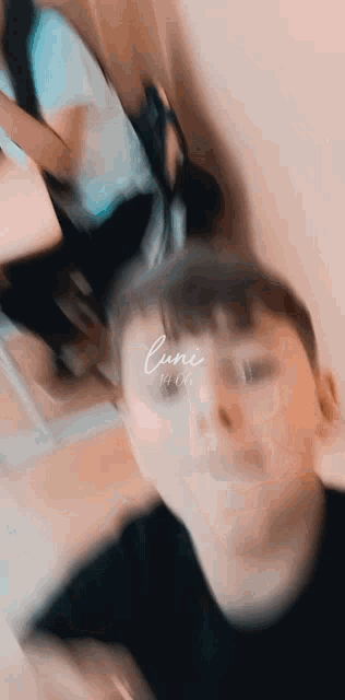 a blurry picture of a person 's face with the word cuni on the bottom right