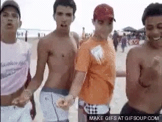 a group of men are dancing on the beach .