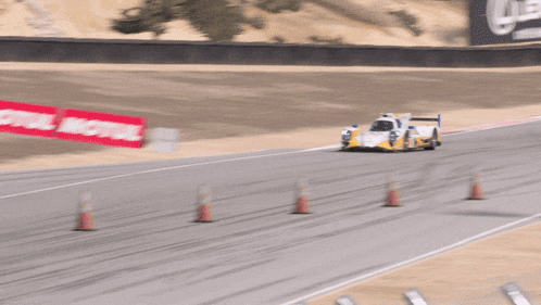 a yellow and white race car with the number 2 on the side