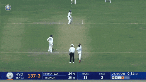a cricket player stands on a field with the score 137-3