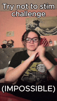 a girl wearing glasses and a shirt that says demon slayer is making a funny face
