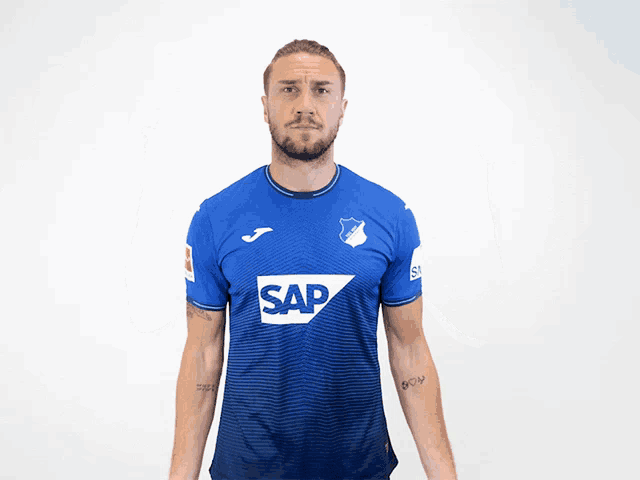 a man wearing a blue shirt with the word sap on the front