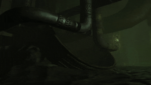 a statue of a man is laying down in a dark room with a green light behind it