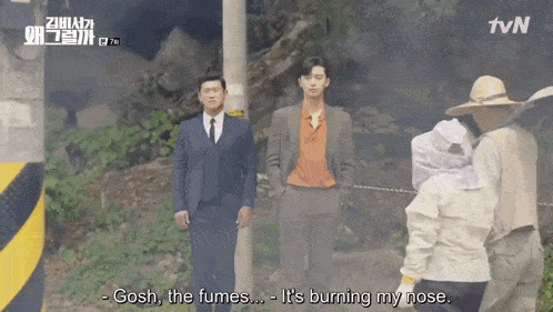 a man in a suit says gosh the fumes it 's burning my nose in a scene from a tvn show