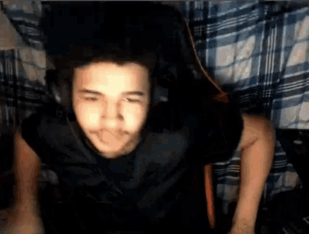 a man wearing headphones is sitting in a chair .