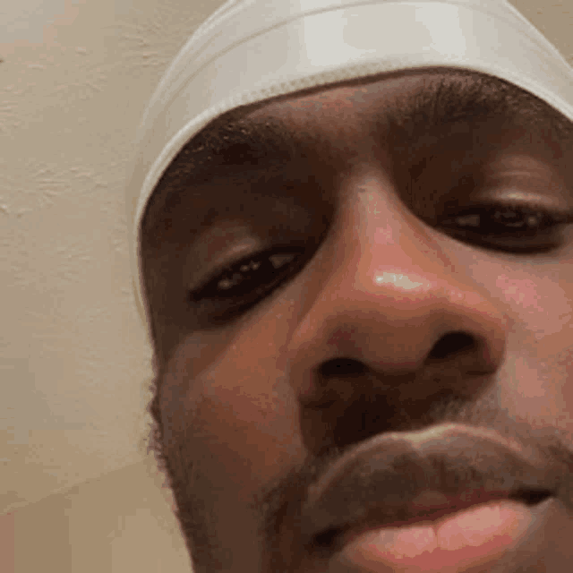 a close up of a man 's face wearing a headband .