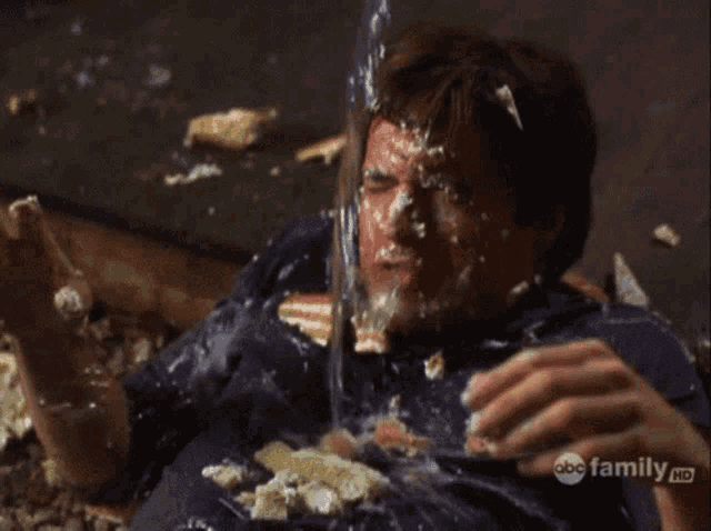 a man with cake on his face is on a abc family hd screen