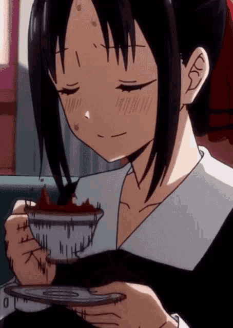 a girl in a school uniform is eating a cake