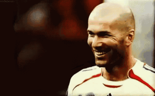 a close up of a man wearing a soccer jersey smiling