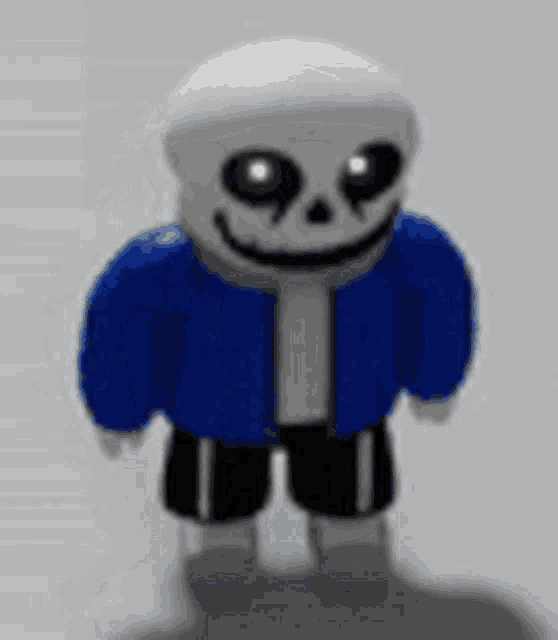 sans from undertale is wearing a blue jacket and black shorts and is smiling .