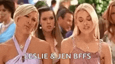 a group of women are standing next to each other in a crowd and one of them is wearing a purple dress .