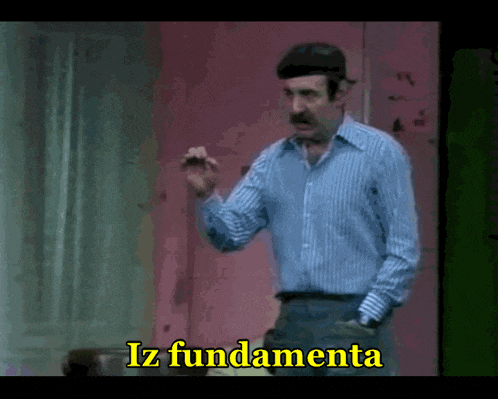 a man in a striped shirt stands in front of a pink wall and says iz fundamentala in yellow letters