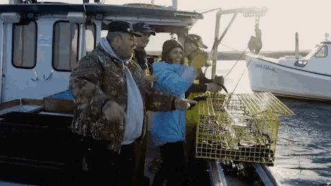 a group of people standing on a boat with a yellow cage in front of a boat that says ' captain ' on it