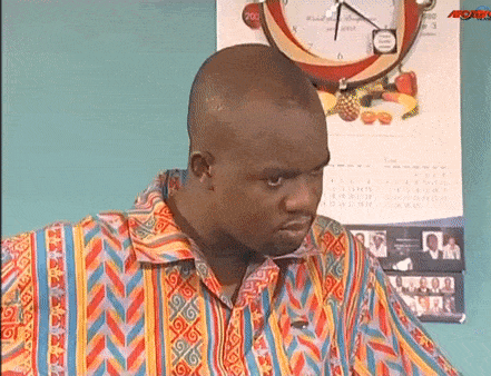 a man in a colorful shirt is looking at something