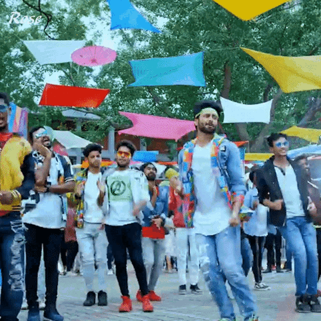 a group of people are dancing in front of a sign that says ' rose '