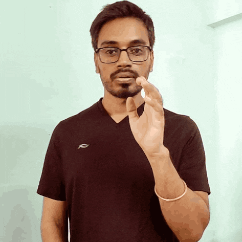 a man wearing glasses and a black shirt with the letter f on the left side