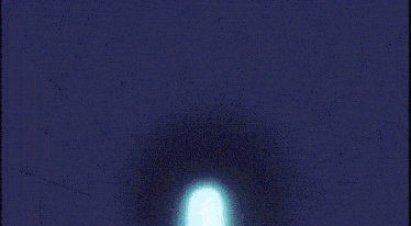 a blue light is coming out of a tunnel