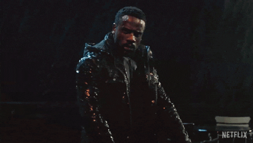 a man in a black jacket is holding a sword and the word netflix is on the bottom right