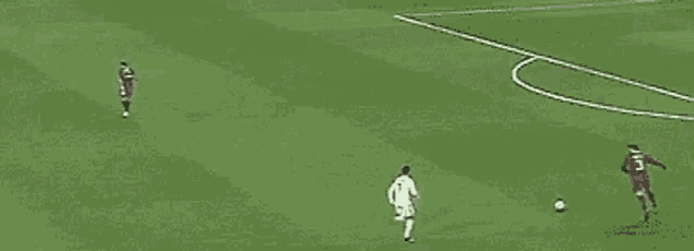 a group of soccer players are playing soccer on a green field .