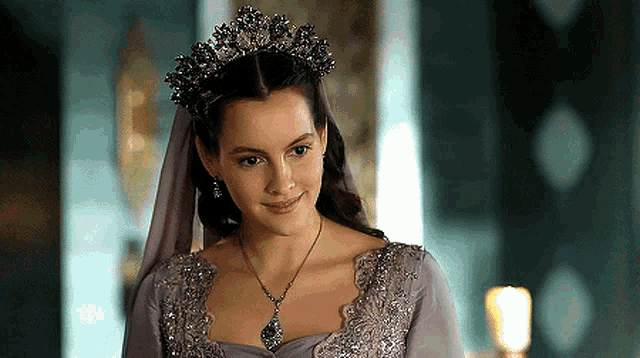 a woman wearing a purple dress and a tiara