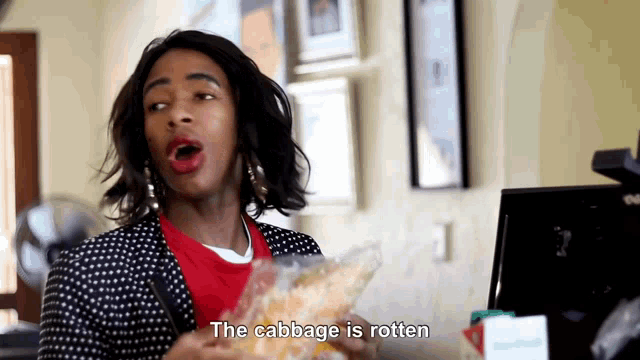 a woman says the cabbage is rotten while holding a bag of food