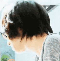 a close up of a person 's head with a blurry background