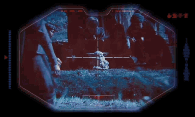 a screen shows a group of people looking through a scope at a baby