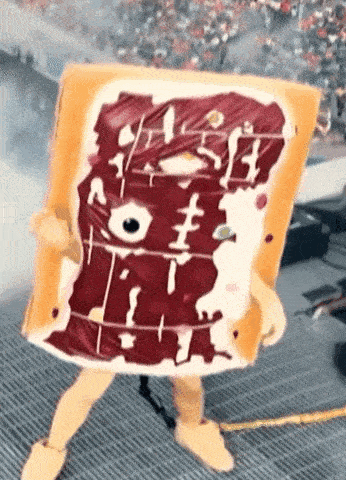 a person dressed as a toaster pastries mascot is holding a piece of toaster pastries .