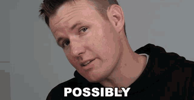 a man in a black hoodie is making a funny face and the word possibly is visible in the corner .