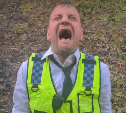 a man wearing a yellow vest and tie is screaming with his mouth open