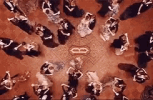 a group of people are dancing in a circle .