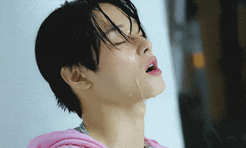 a close up of a person 's face with water dripping from their mouth