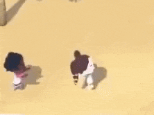a couple of people are standing next to each other on a sandy surface .