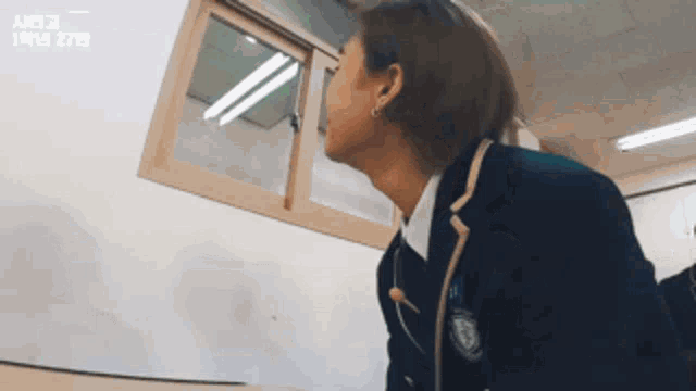 a man in a school uniform is looking up at something