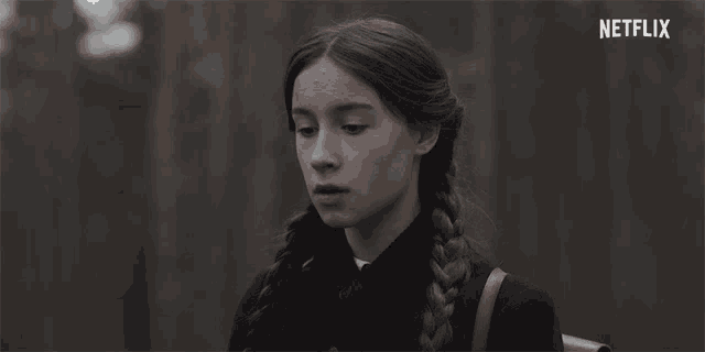 a girl with a braided hair and a netflix logo on the bottom