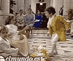 a man in a yellow coat is standing next to a woman in a white dress