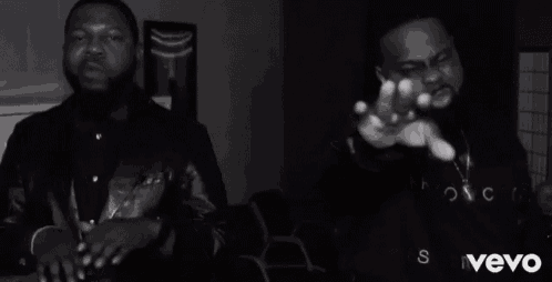 two men are standing next to each other in a black and white photo with the word vevo in the corner