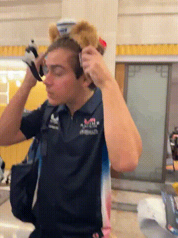 a man wearing headphones and a shirt that says red bull on it