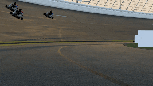 a man in a helmet is driving a cart on a race track
