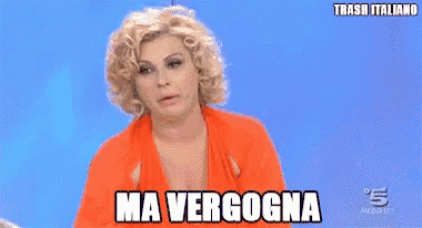 a woman in an orange dress is flexing her muscles and the words ma verogna are above her