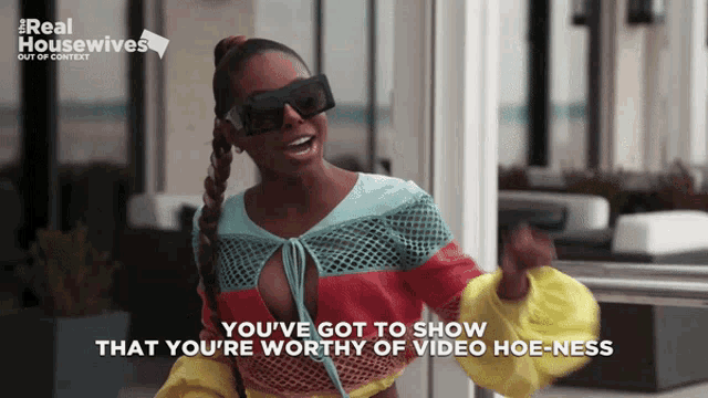 a woman wearing sunglasses says you 've got to show that you 're worthy of video hoe-ness