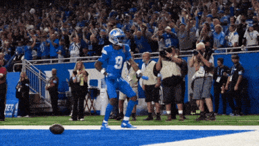 a football player with the number 9 on his jersey is running on the field