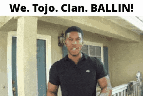 a man in a black shirt is standing in front of a house and says we tojo clan ballin